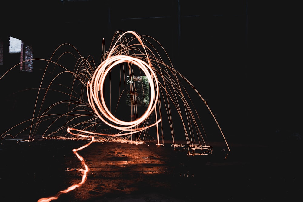 steel wool photography of man standing on the ground