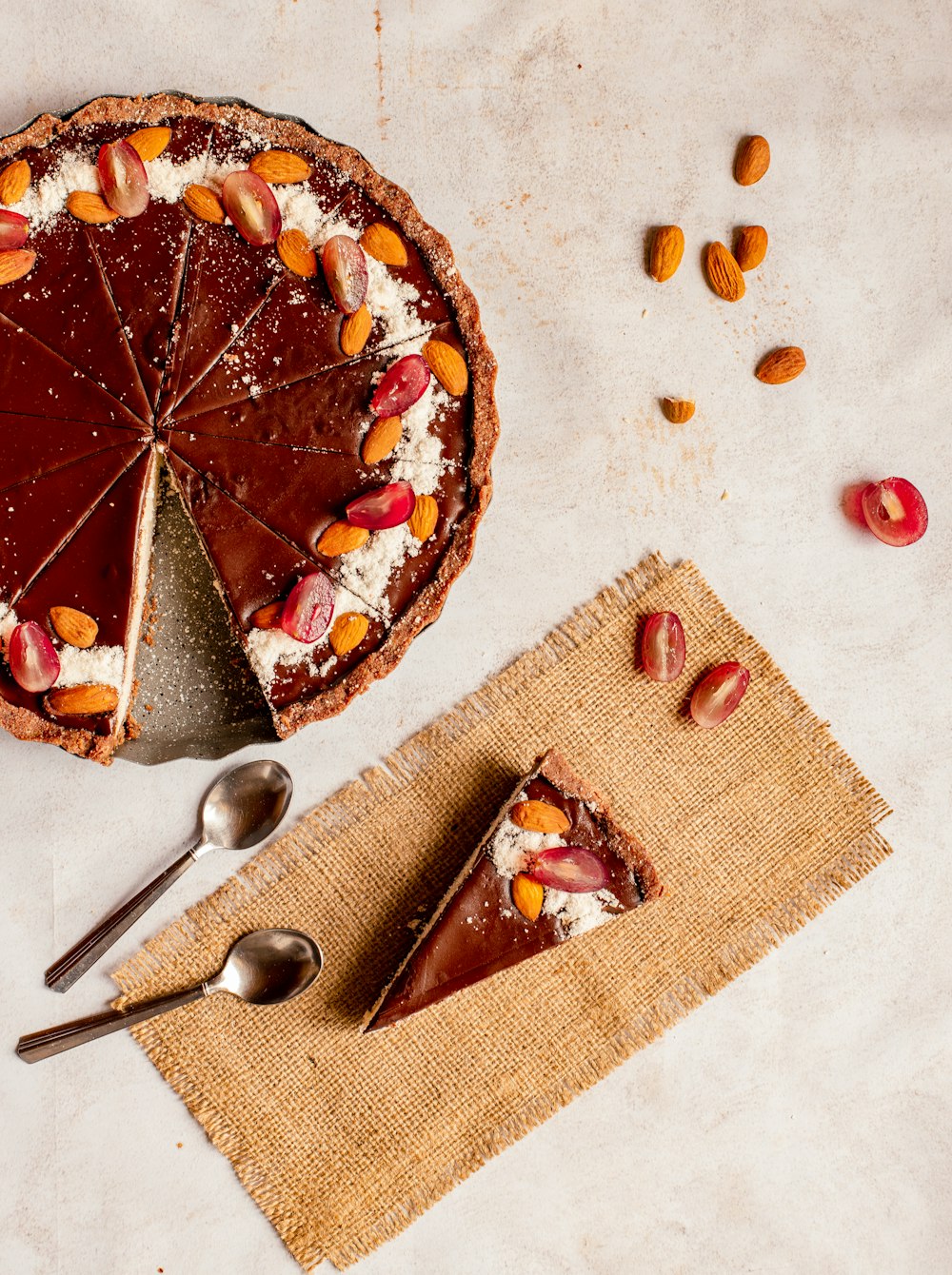 sliced pie on white ceramic plate beside stainless steel spoon and fork