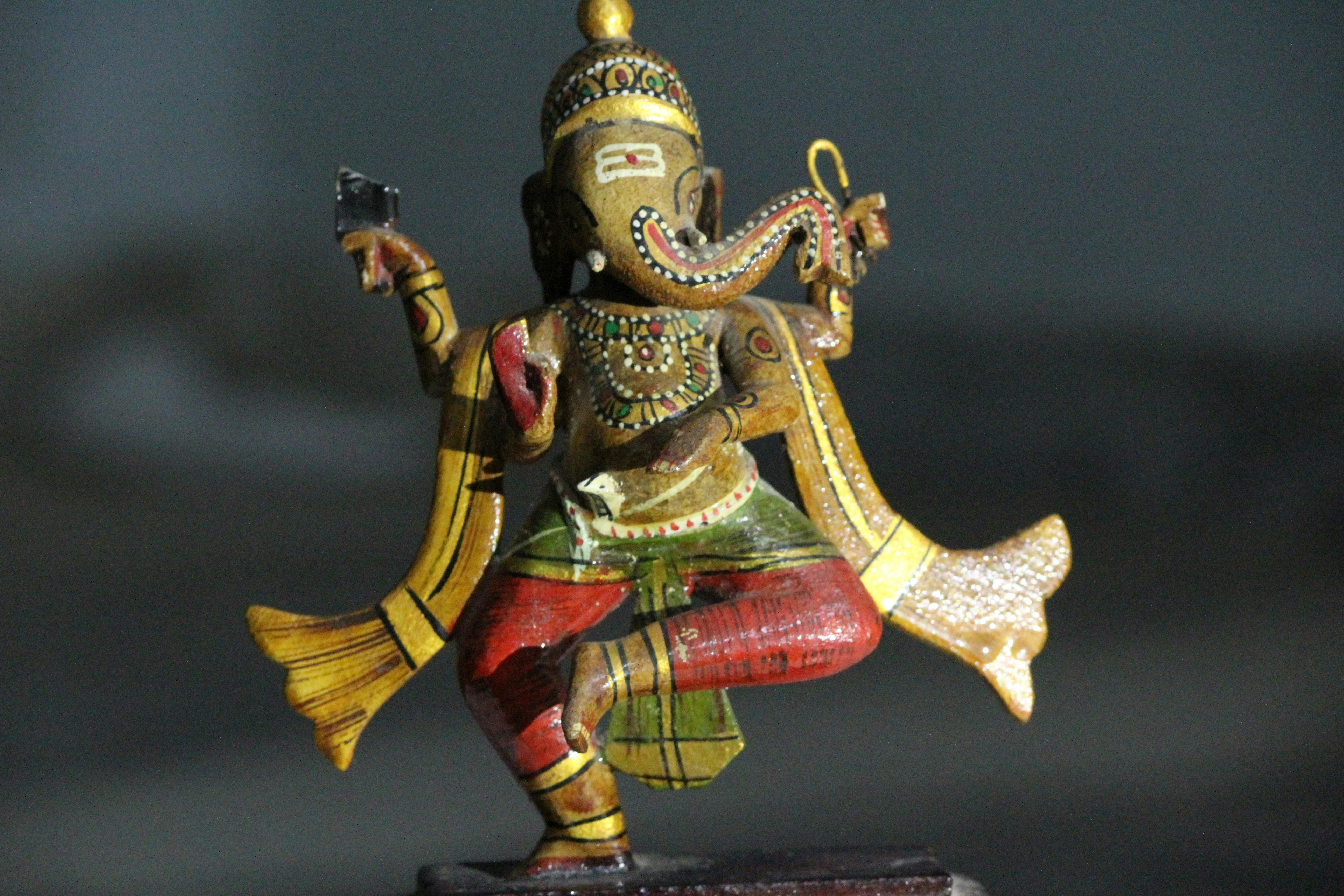 Gold red deity figurine