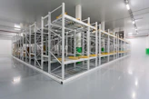 Vibrant yellow powder-coated industrial shelving in a modern warehouse