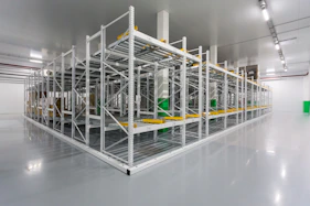 A commercial warehouse with polished floors and organized shelves, freshly cleaned.