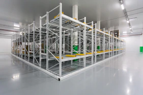 A commercial warehouse with polished floors and organized shelves, freshly cleaned.