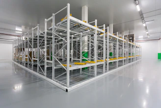 A sleek, modern warehouse with rows of neatly organized shelves illuminated by soft blue lighting.