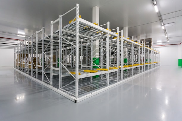 Photo of a large industrial machinery warehouse with stacked equipment and organized shelves.