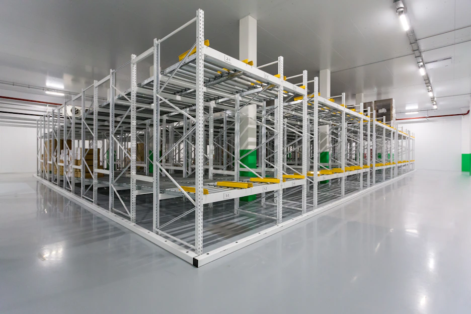 A sleek warehouse interior with neatly stacked industrial supplies and equipment under bright, clean lighting.