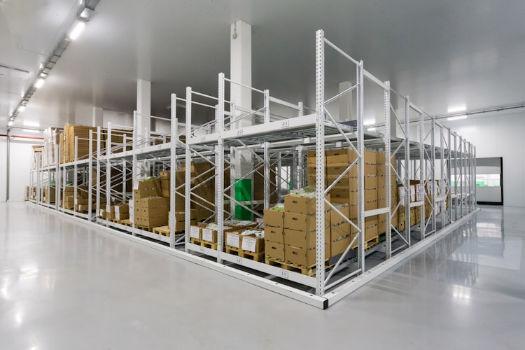 Interior view of a large modern warehouse with high shelving and organized inventory
