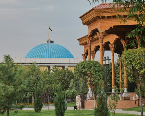 White dome building near green trees during daytime — Tashkent, Uzbekistan
