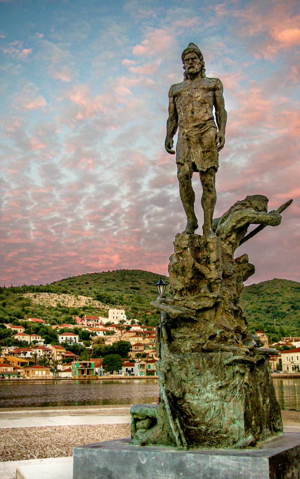 man statue under cloudy sky during daytime