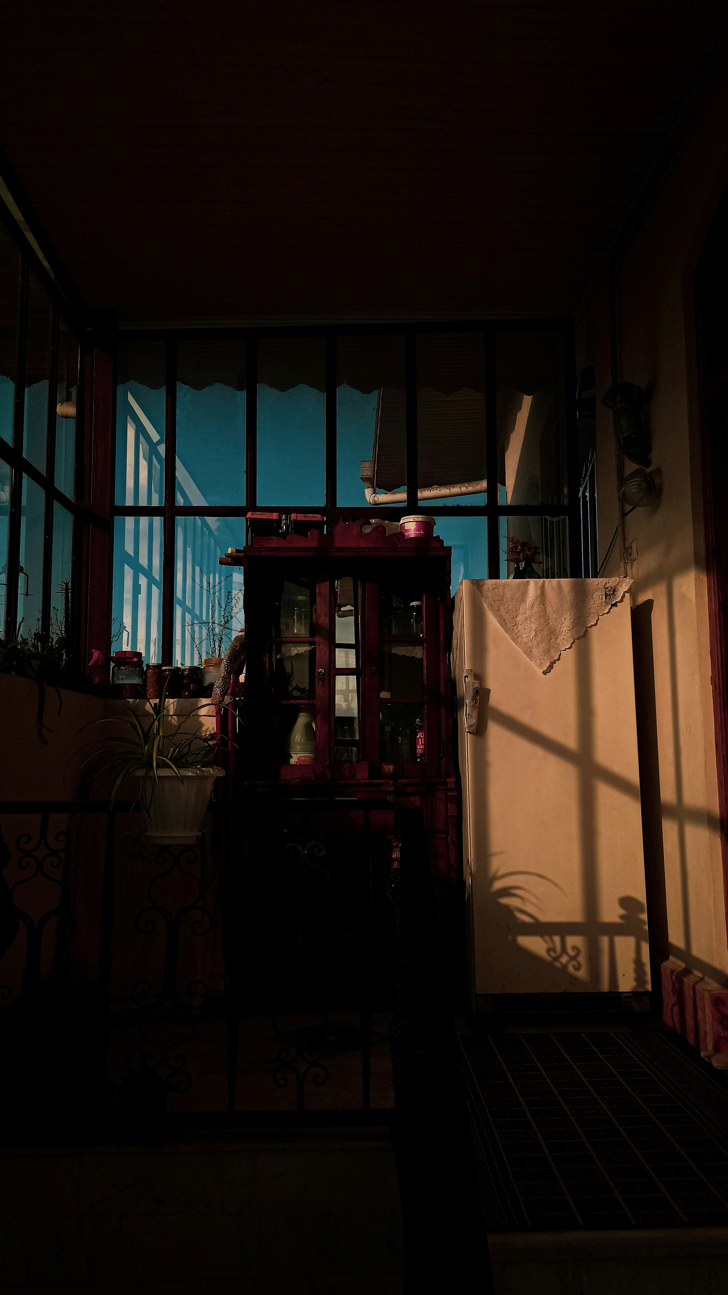 brown wooden cabinet near window
