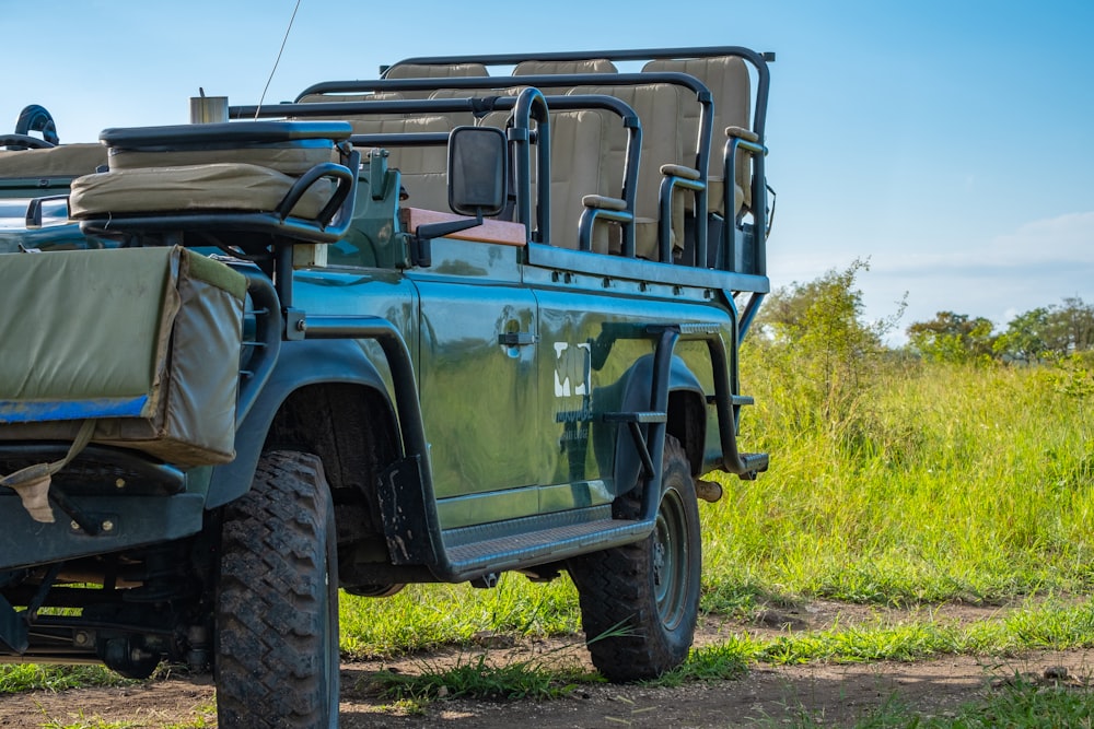 green and black jeep wrangler on green grass field during daytime