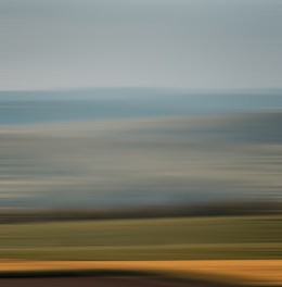 brown sand under white clouds during daytime