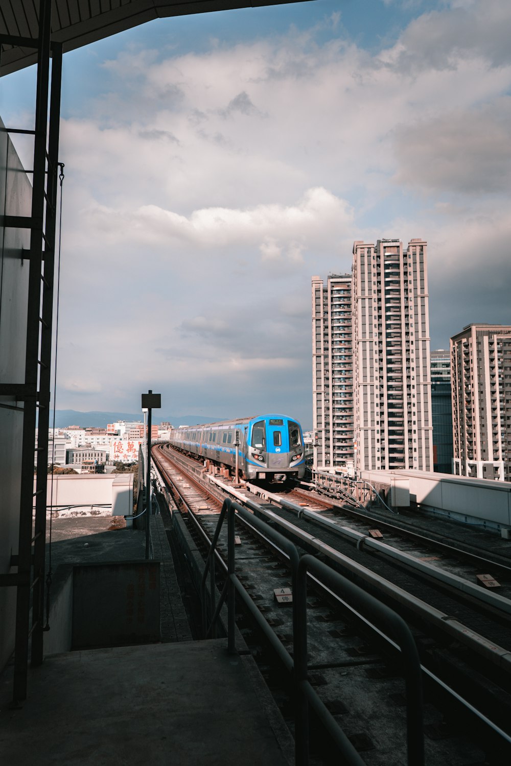 blue and white train on rail during daytime