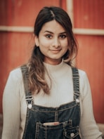woman in white long sleeve shirt and blue denim dungaree