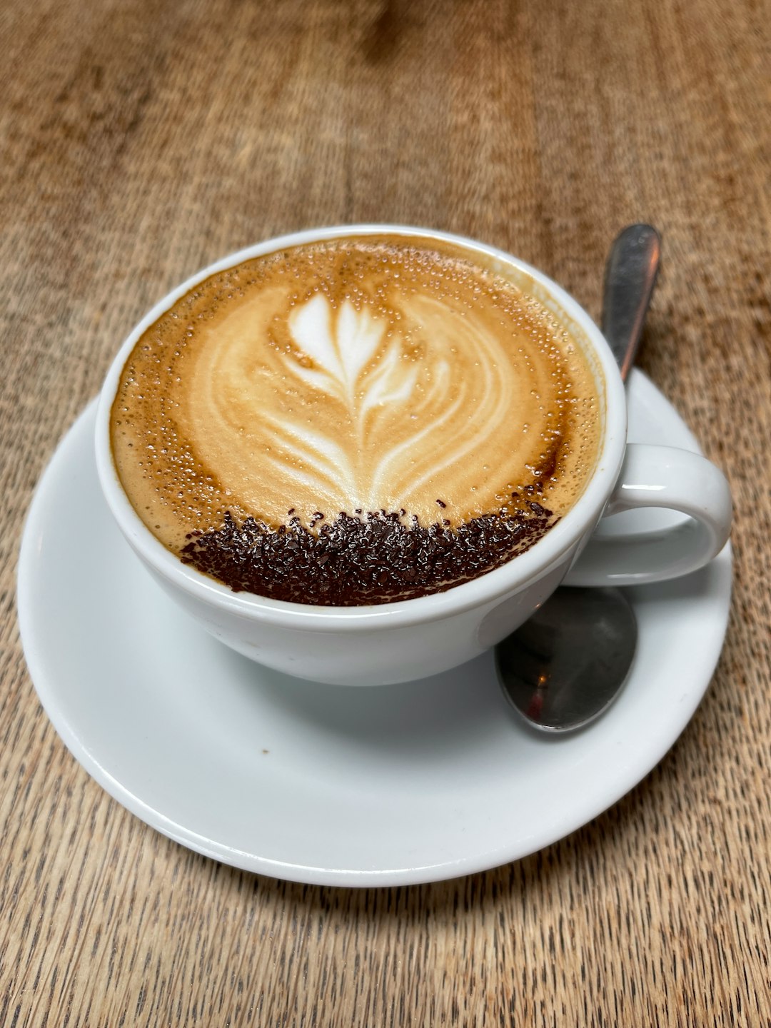 white ceramic mug with cappuccino