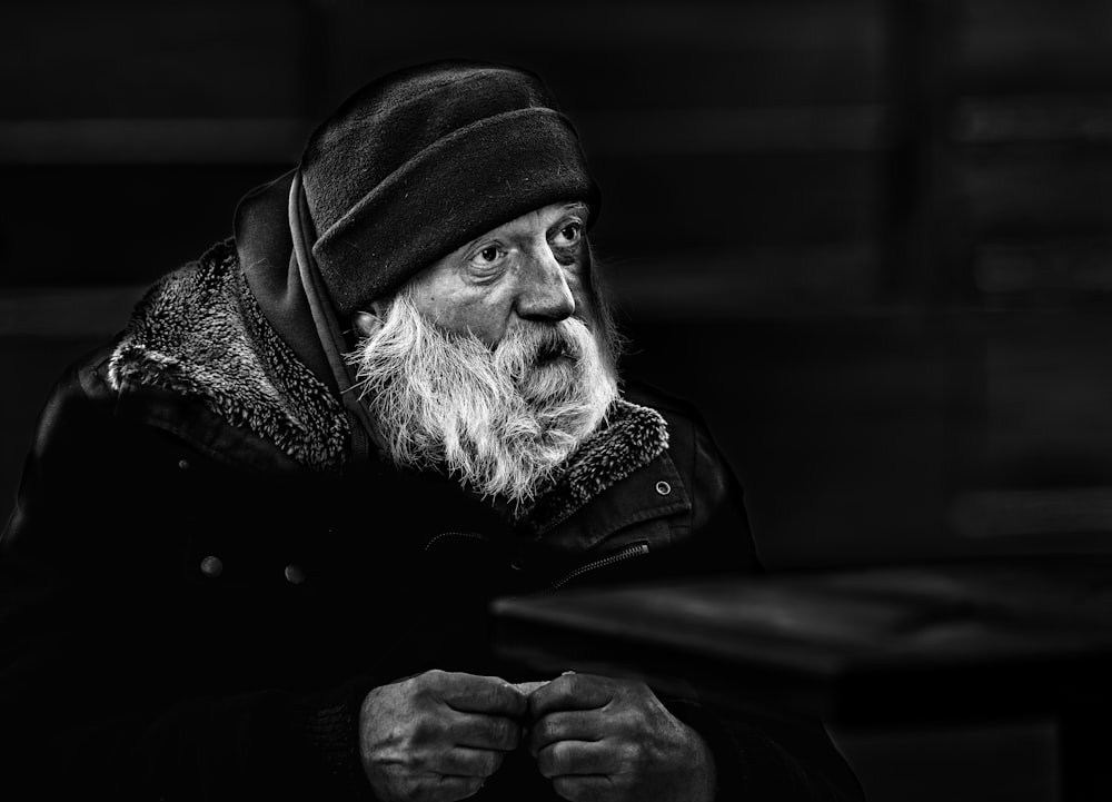 grayscale photo of man wearing black and white scarf
