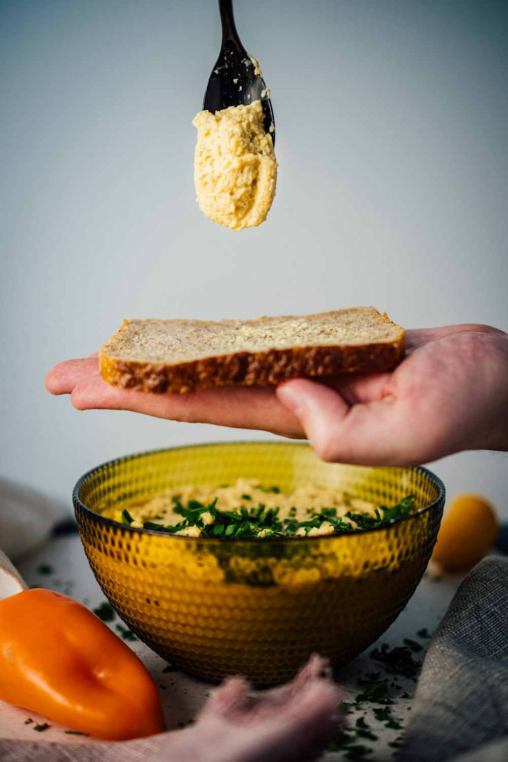 person holding sliced bread with butter