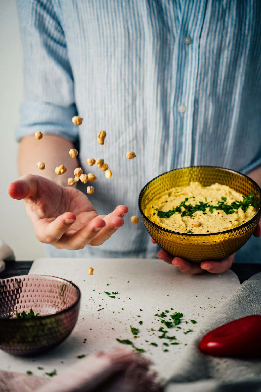 person holding yellow ceramic bowl with green liquid