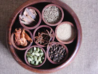 brown wooden round bowl with green and brown leaves