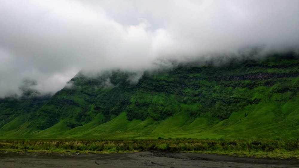 green mountain under white clouds during daytime