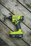 green and black cordless hand drill