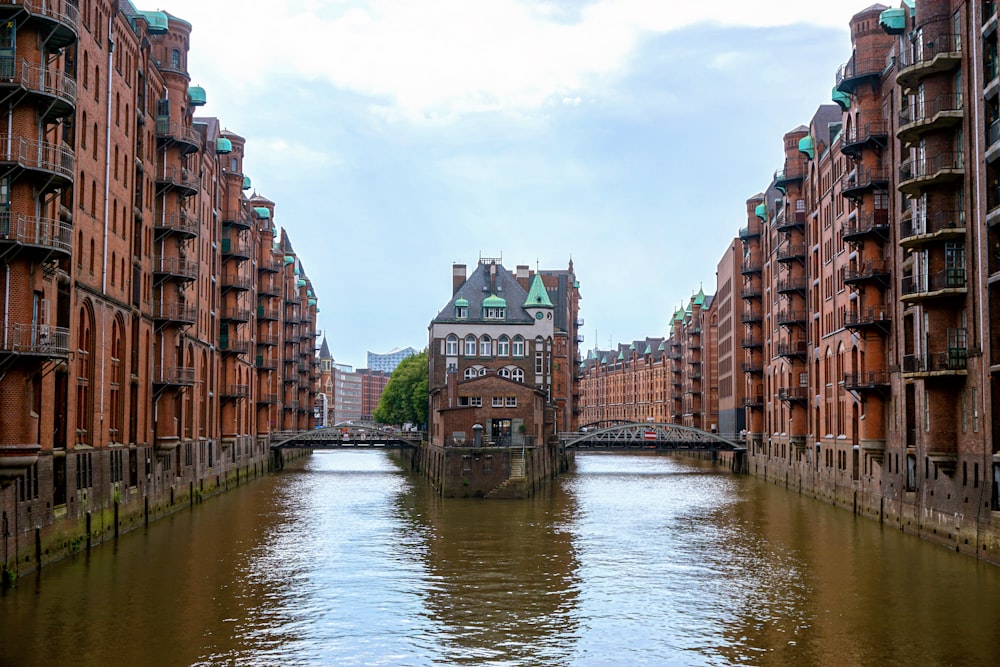 brown concrete building beside river during daytime