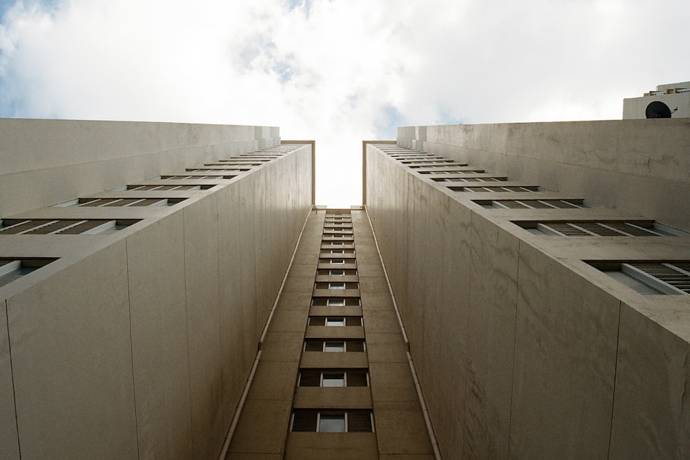 gray concrete building under white clouds during daytime