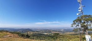 Aerial view of a network of communication towers spread across a green landscape.
