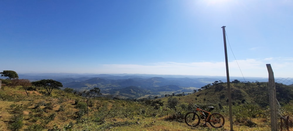 black mountain bike on green grass field during daytime