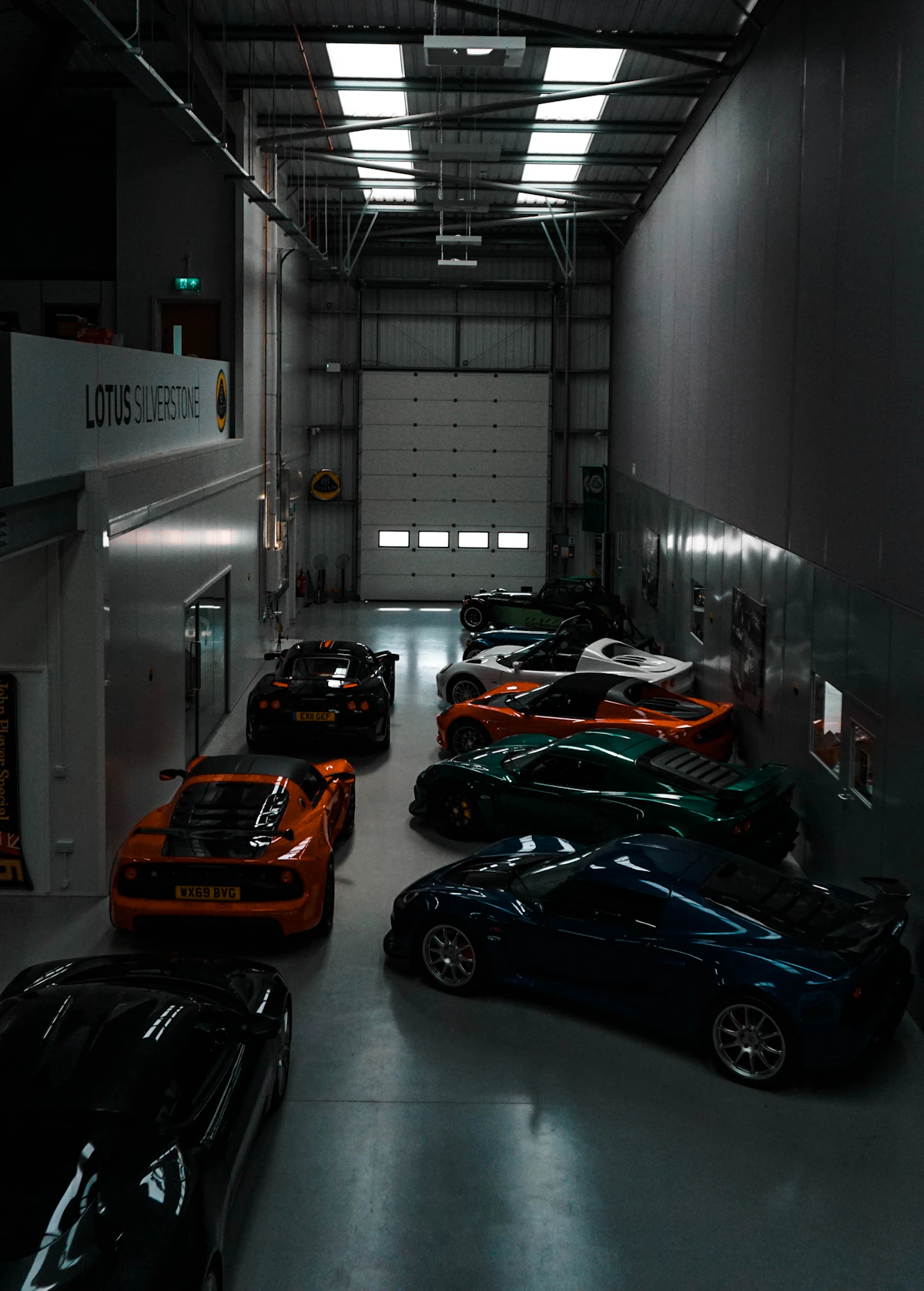 Custom-styled car with aftermarket wheels and stance in a dark studio