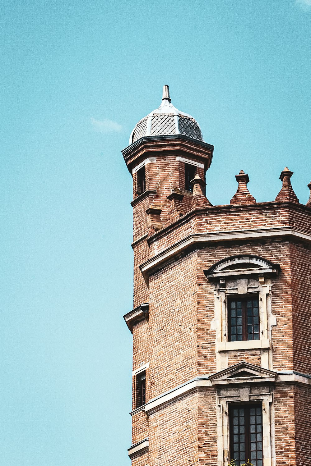 brown brick building under blue sky during daytime