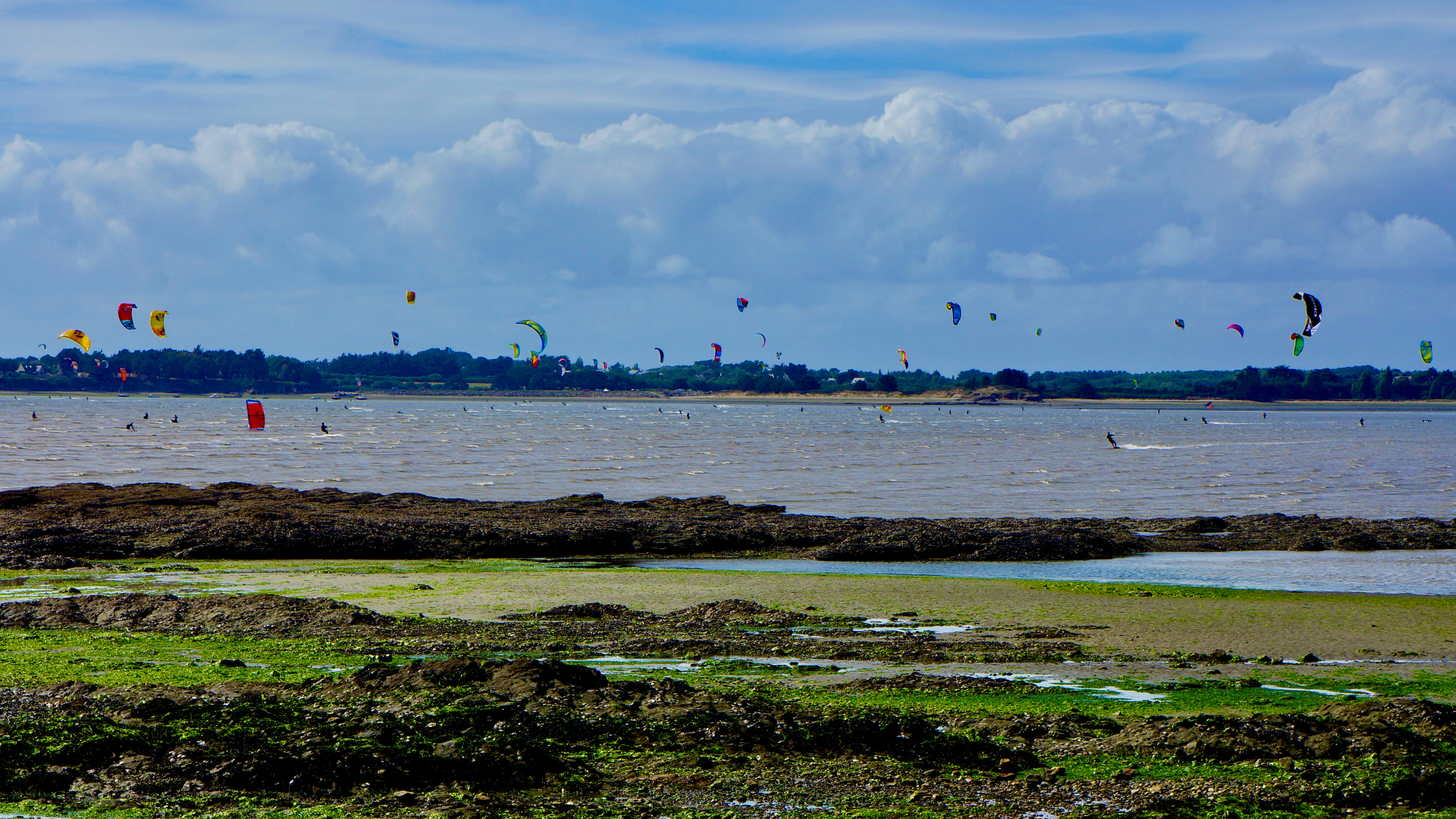 Kite surfers at low tide