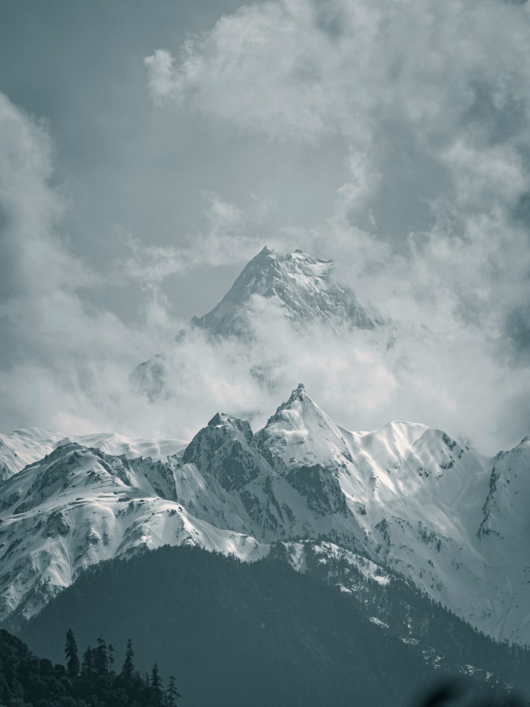 snow covered mountain under cloudy sky during daytime