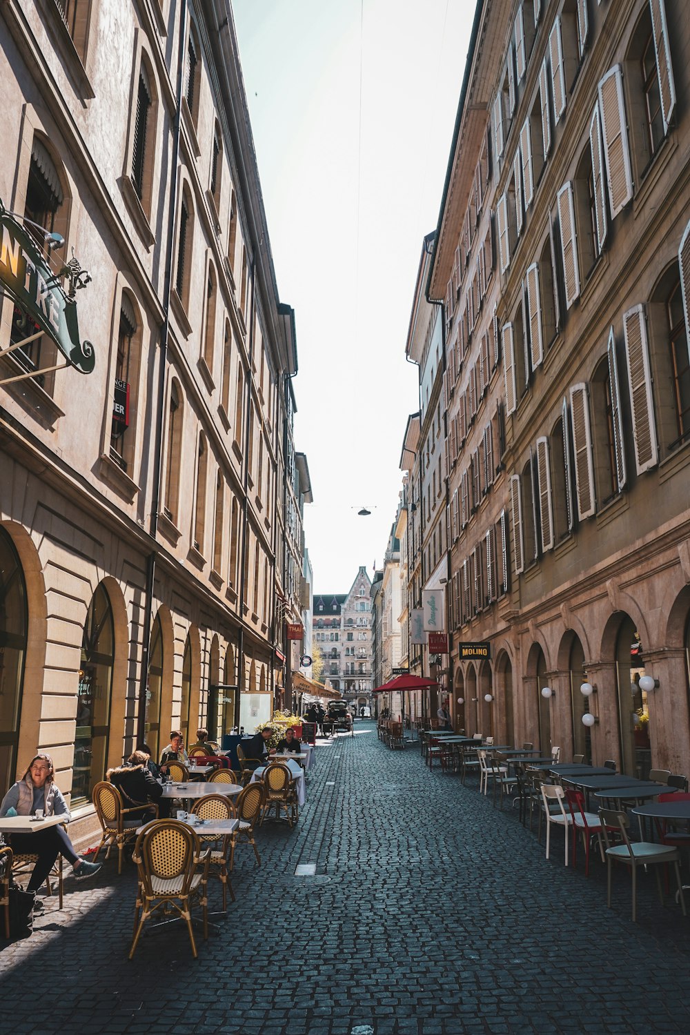 people sitting on chair near building during daytime