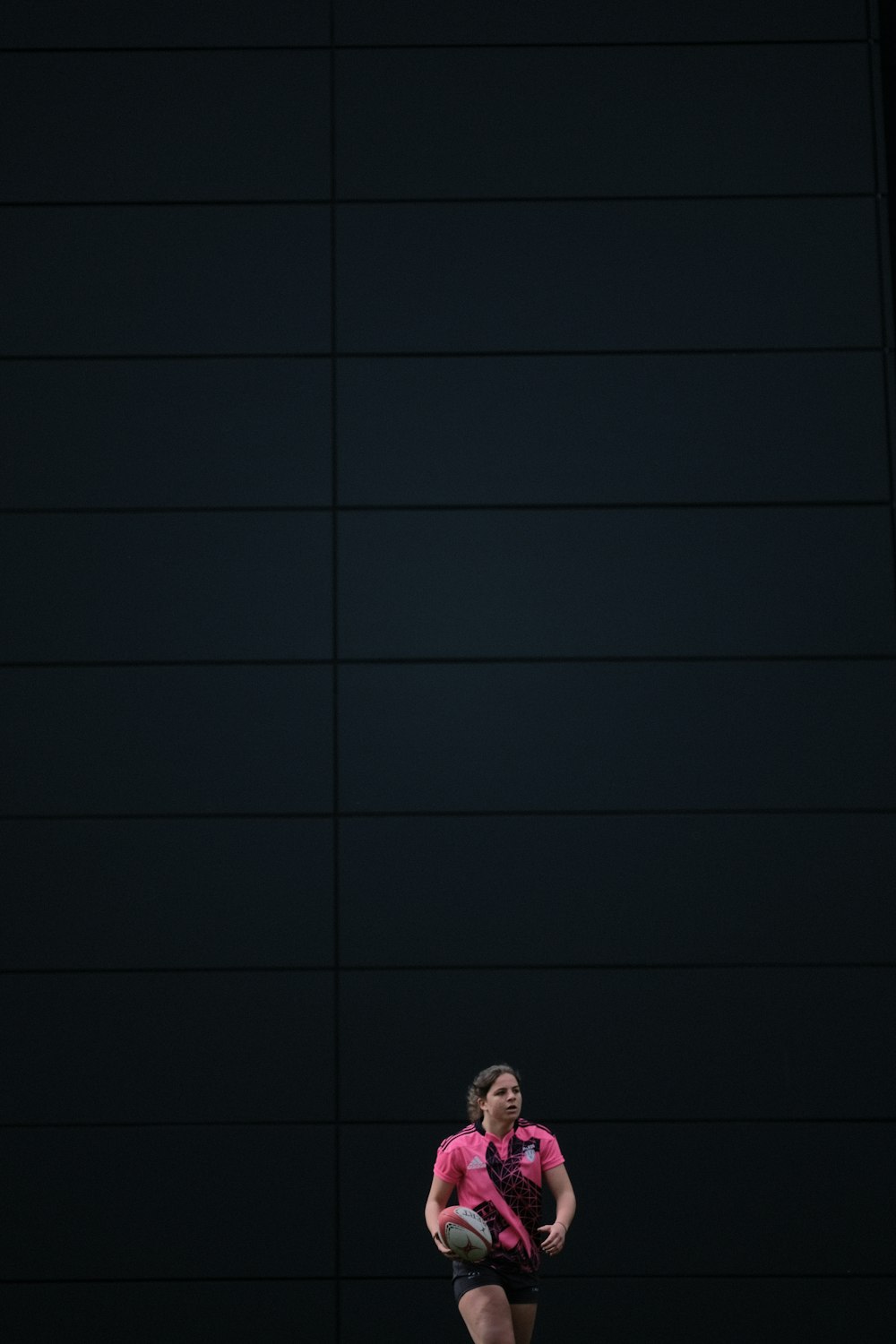 person in black pants standing on black floor