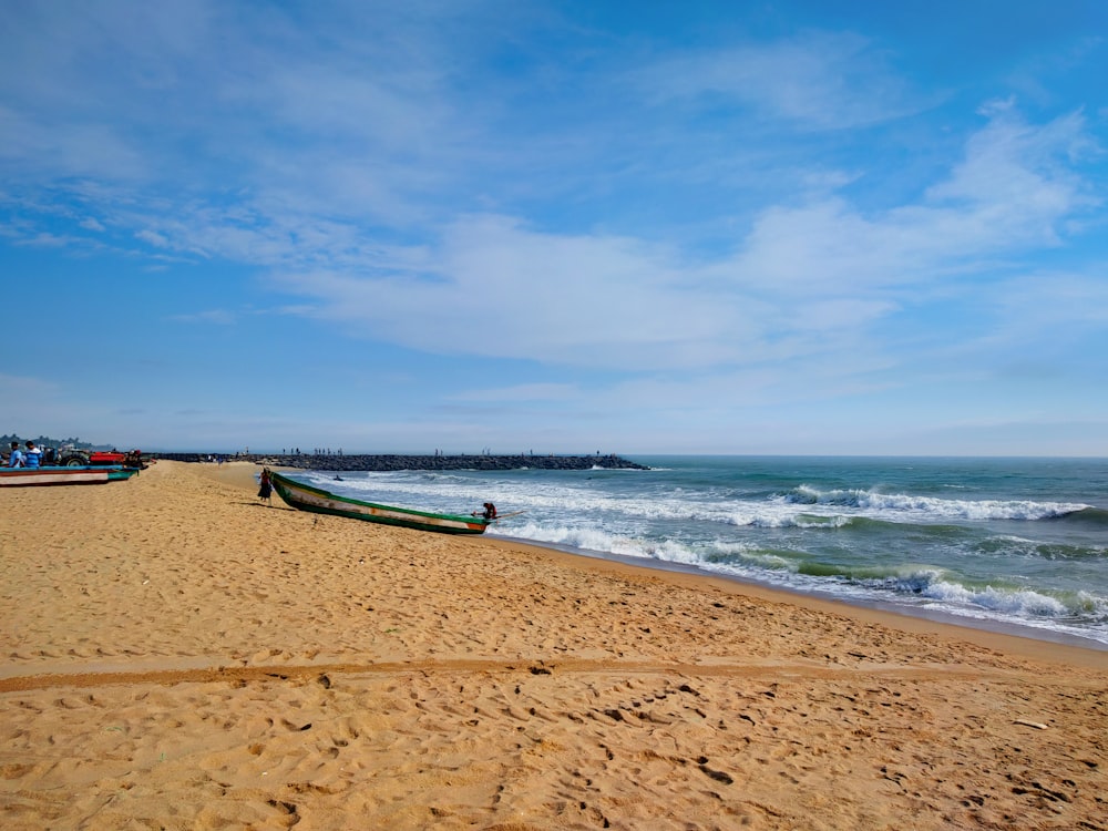 blue and white boat on beach during daytime