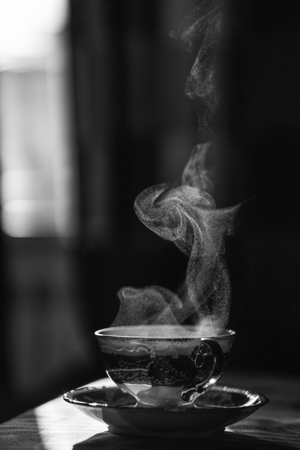grayscale photo of smoke in round container