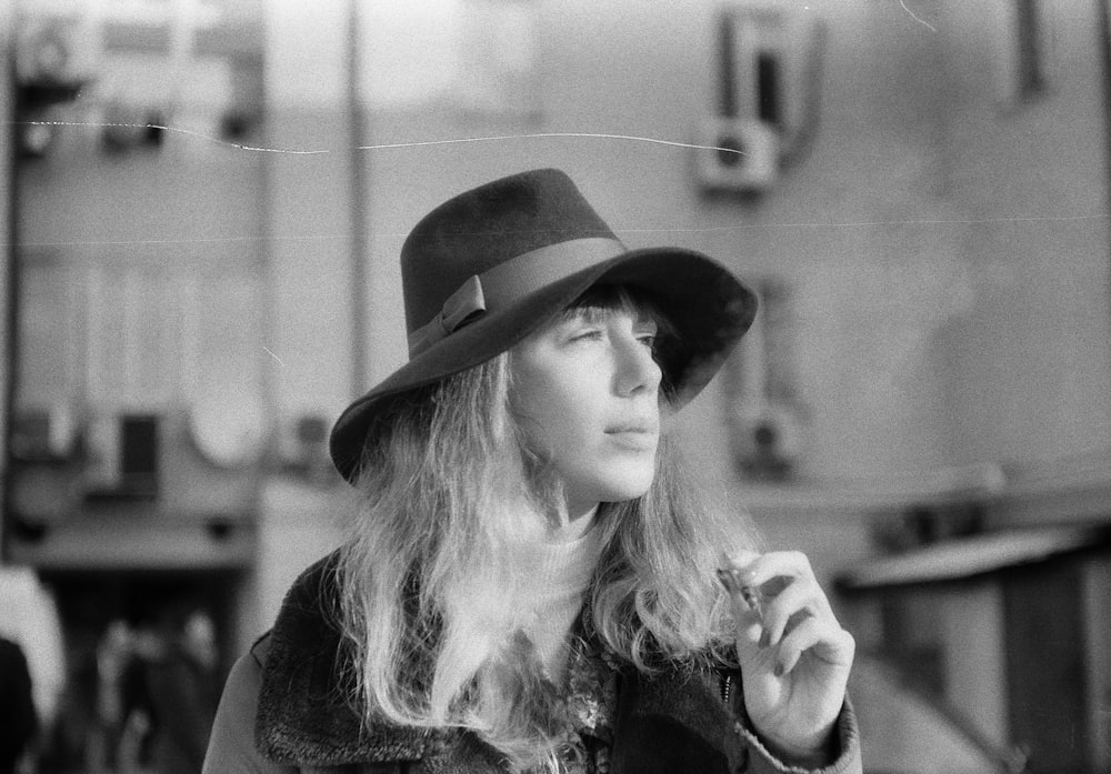 grayscale photo of woman wearing hat