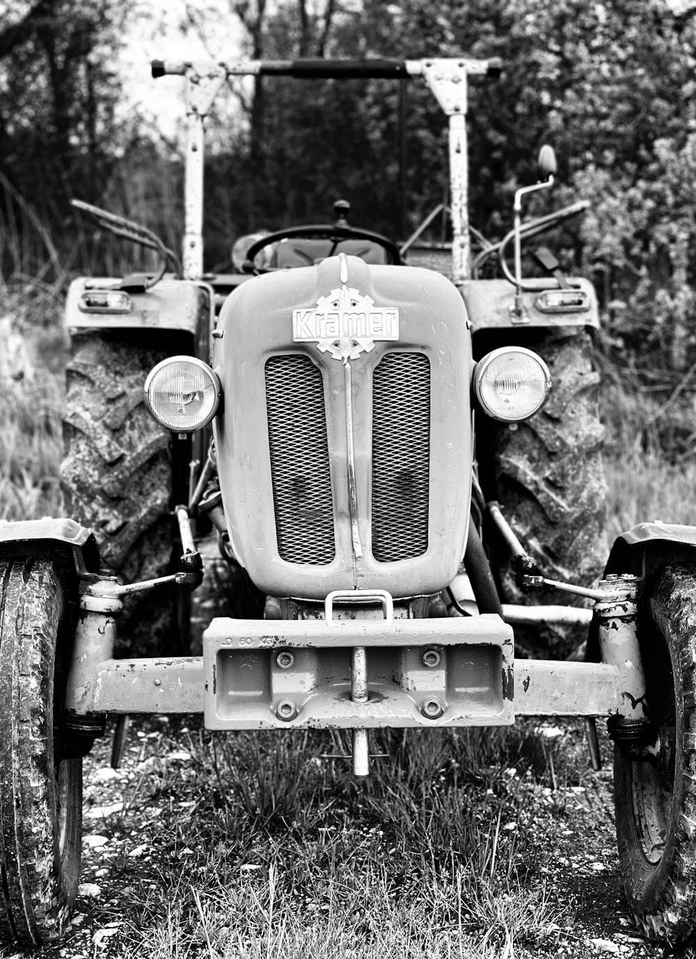 grayscale photo of tractor on grass field