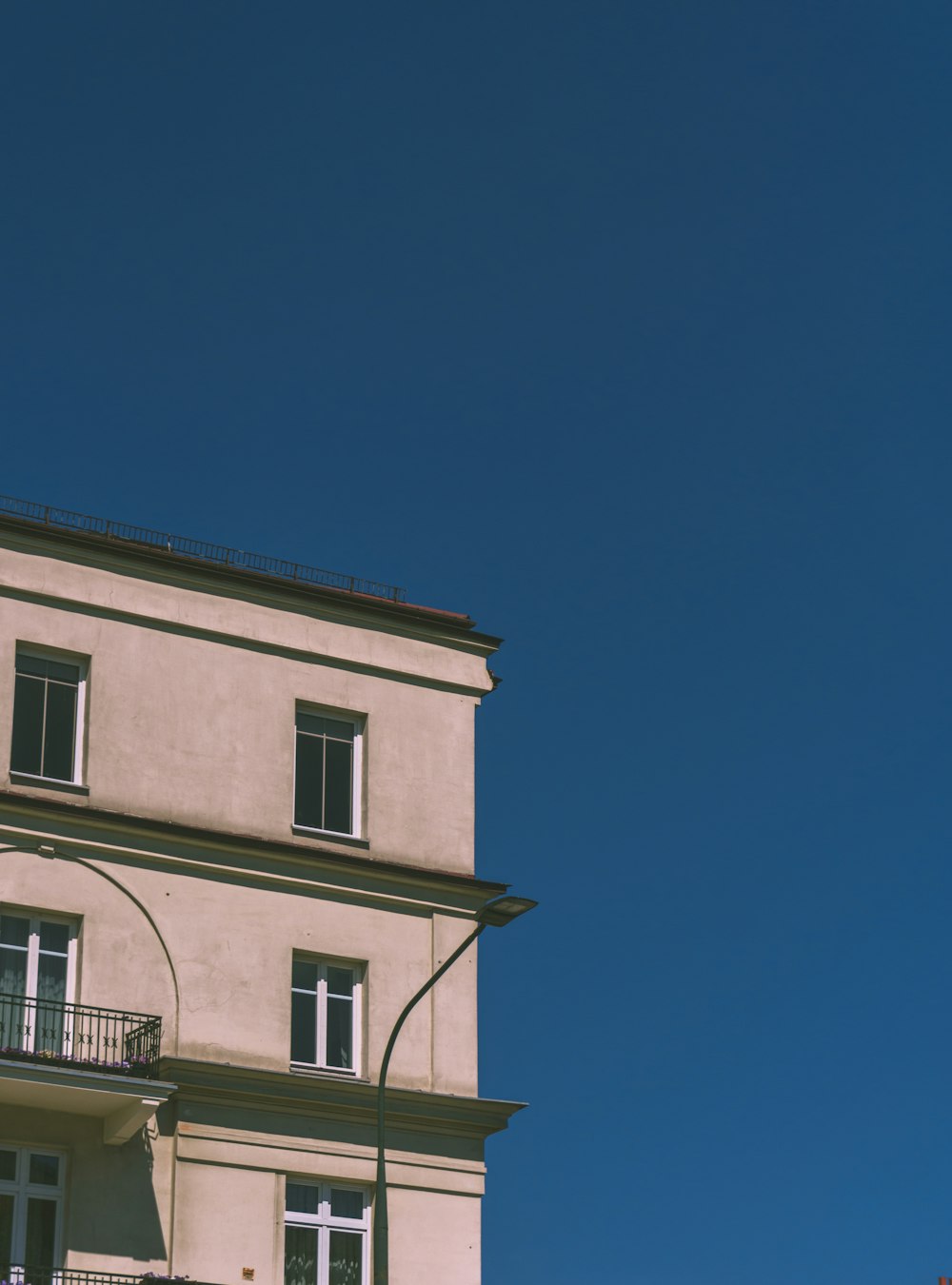 Edificio de hormigón blanco bajo el cielo azul durante el día