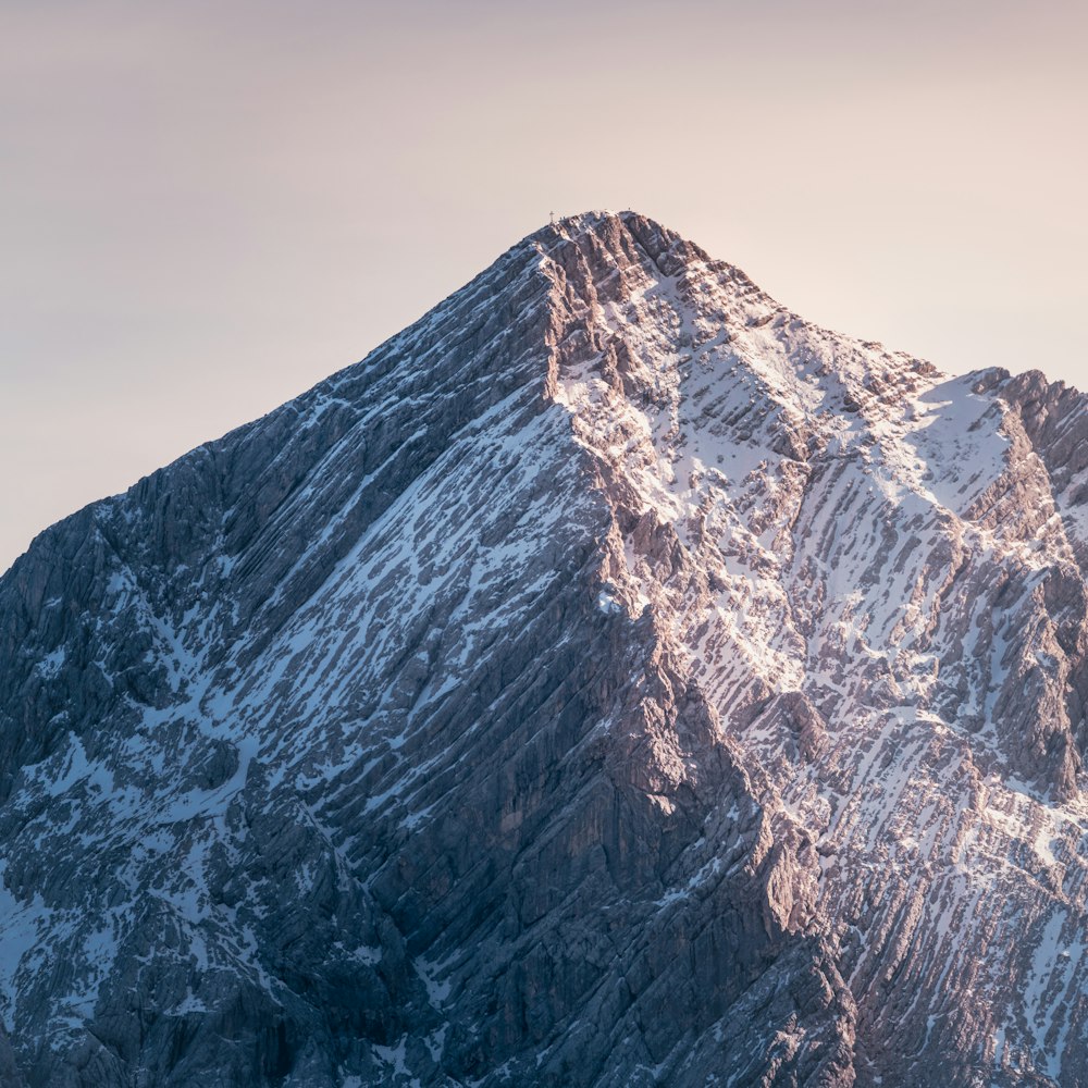 brown and white mountain under gray sky