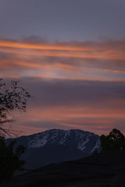 Elegant canvas art featuring a serene mountain landscape at sunset with warm beige and soft gold hues