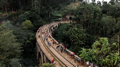 people walking on train rail during daytime