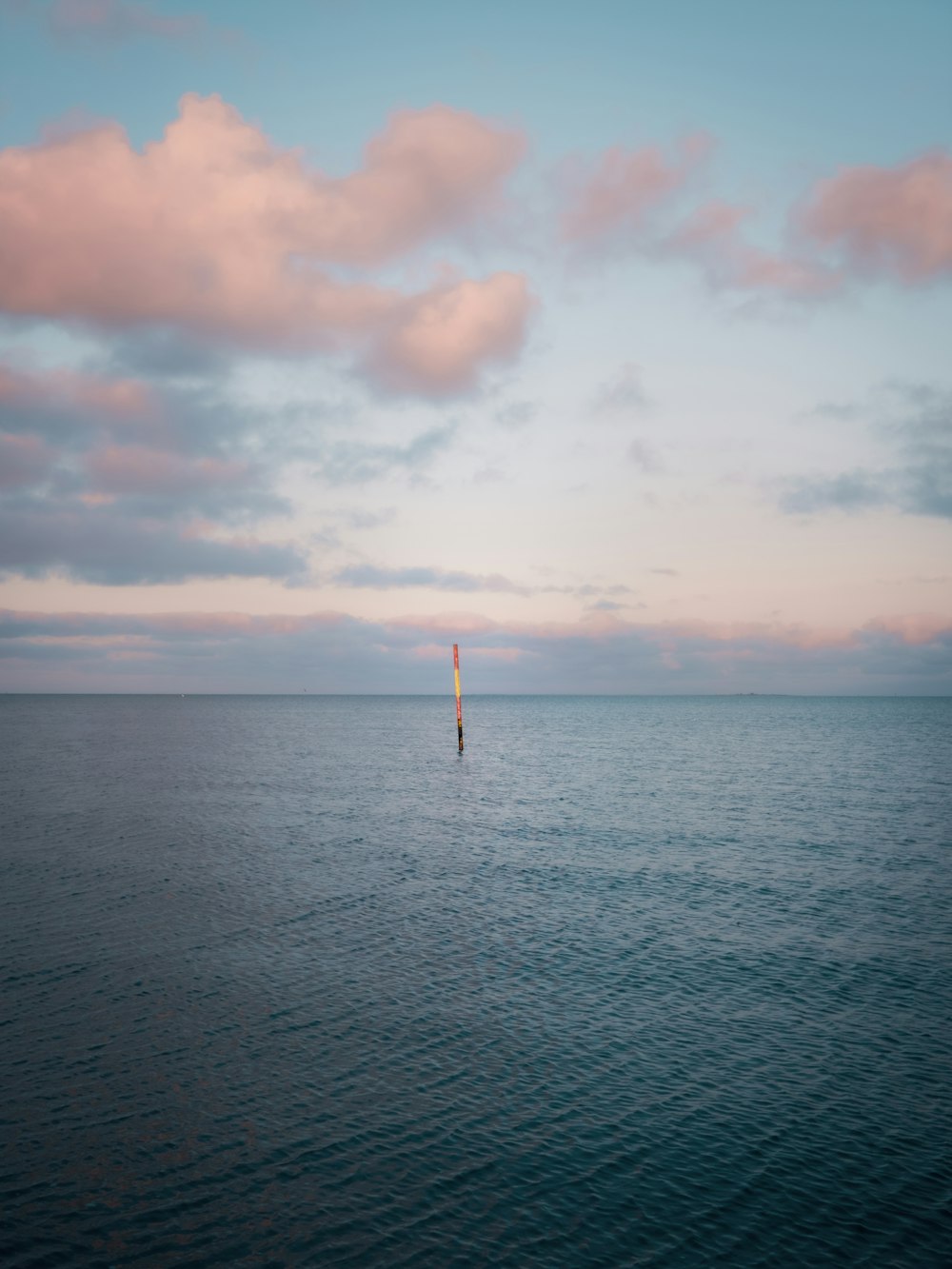 body of water under cloudy sky during daytime