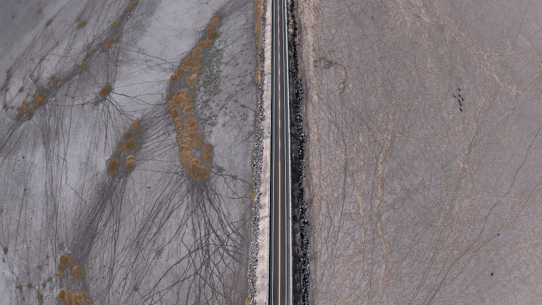 aerial view of road between snow covered ground