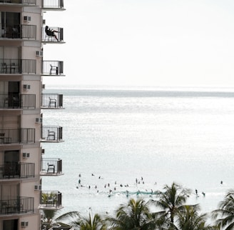 brown and white concrete building near body of water during daytime