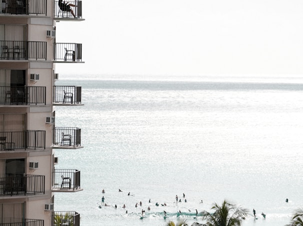 brown and white concrete building near body of water during daytime