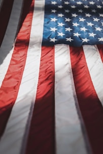 A close-up of a veteran's hand on a flag, symbolizing pride and honor.