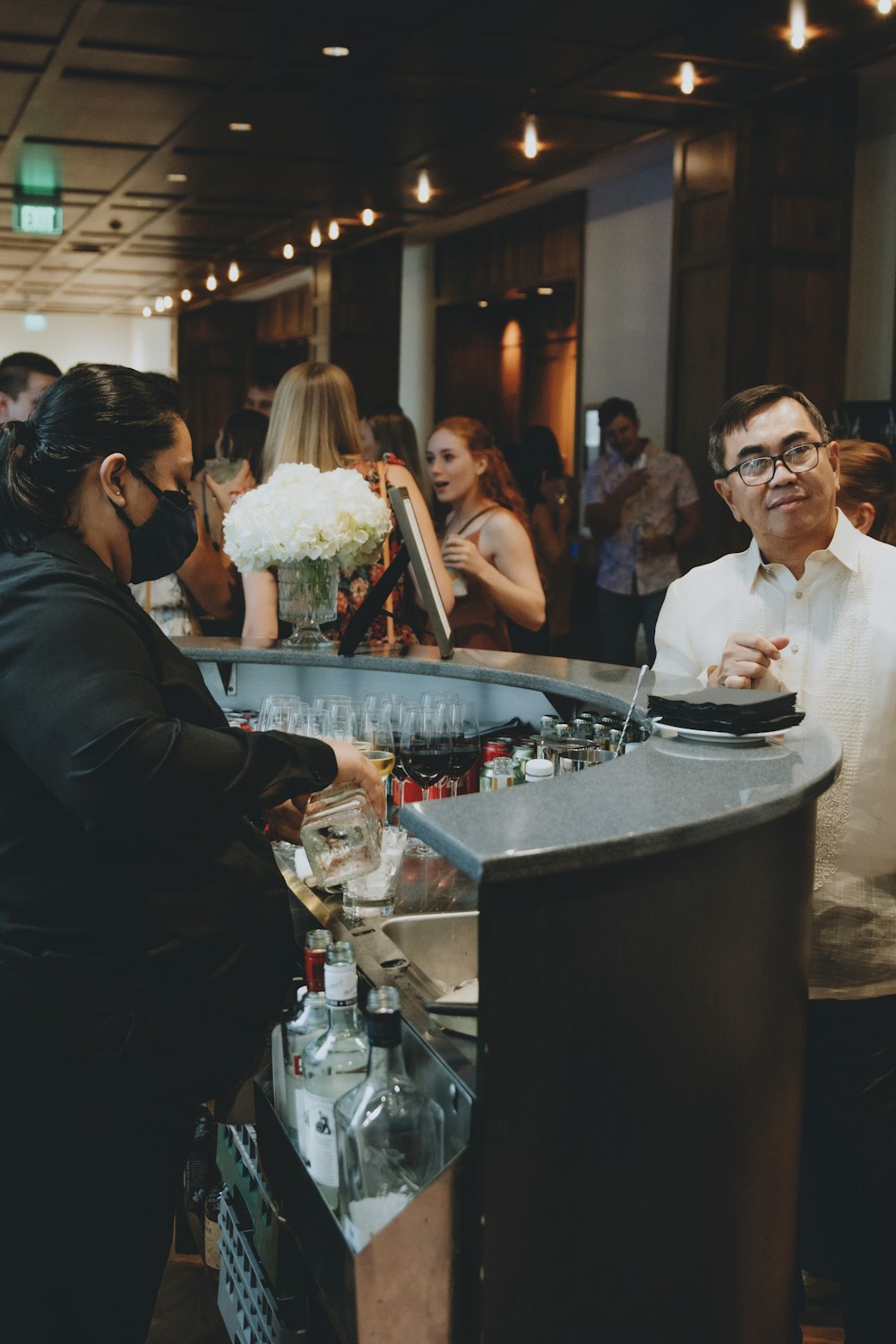 man in black suit jacket holding white bouquet