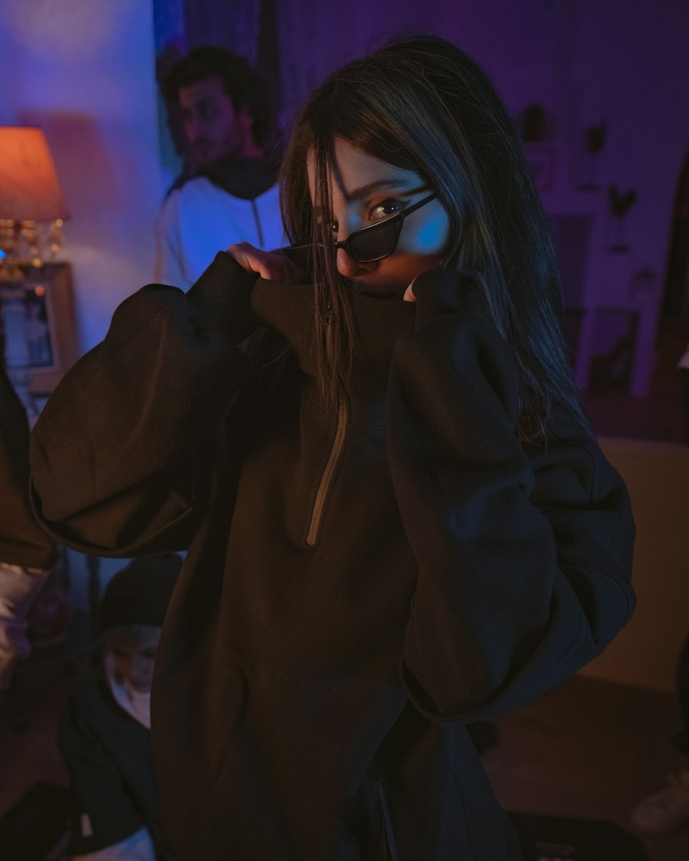 woman in black hoodie wearing black framed eyeglasses