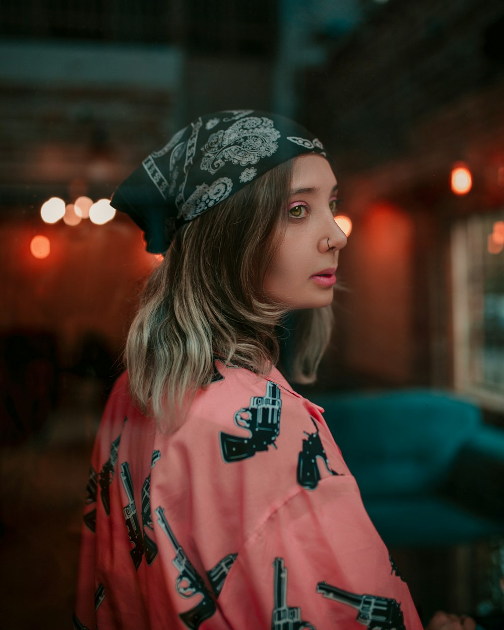 woman in red and white sweater wearing black and white floral bandana